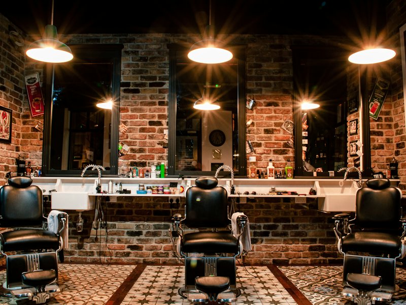 Barbershop interior with leather chairs and warm lights